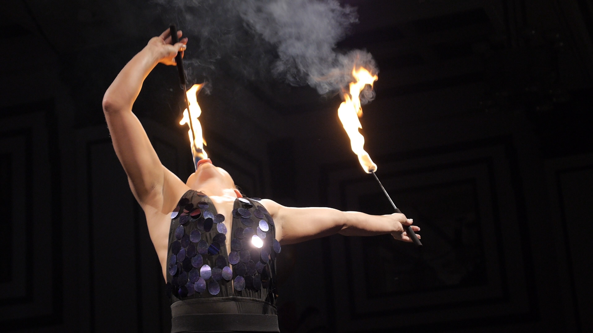 A still of a girl eating fire in a promotional video
